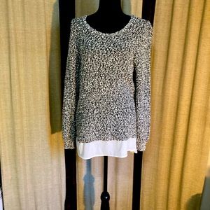 Black and white sweater by Calvin Klein. Ruffle at bottom size medium.Very nice